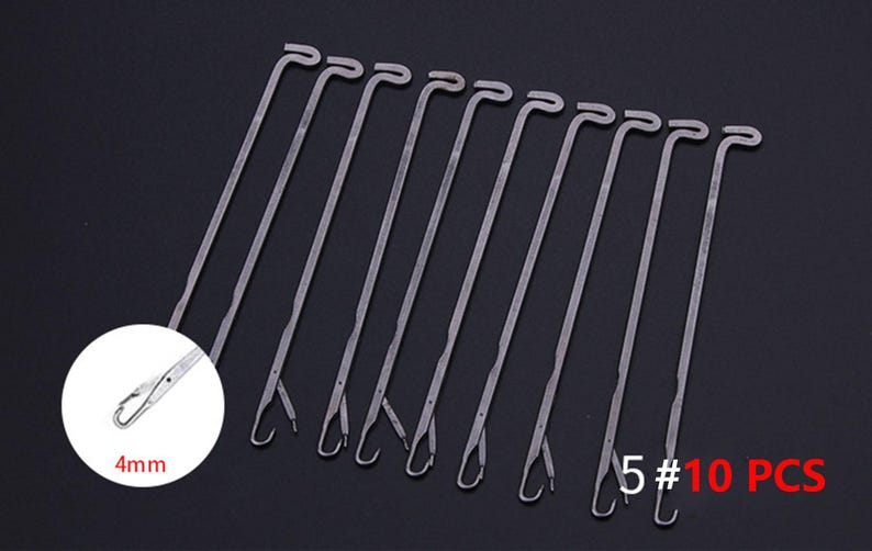 May include: A set of 10 silver-colored metal knitting machine needles, each featuring a latch hook mechanism at the tip. A circular inset shows a magnified view of the hook with the text 4mm, and the text 5# 10 PCS is visible in red.