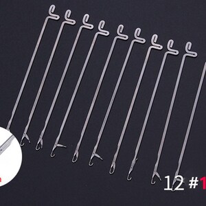 May include: A set of 10 silver-colored metal latch hook needles, each featuring a straight shaft with a looped top and a hinged latch mechanism at the tip. A circular inset shows a close-up of the hook tip with the text 2mm, and 10 PCS is visible.
