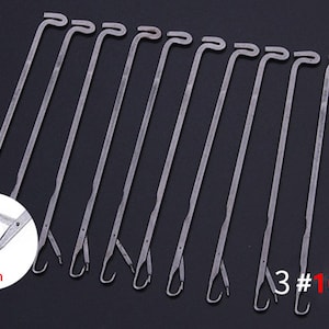 May include: A set of 10 silver-colored metal knitting machine needles, each featuring a hooked end and a latch mechanism. A circular inset shows a close-up of the needle tip with the text 6mm, while the text 3 #10 PCS appears in the corner.