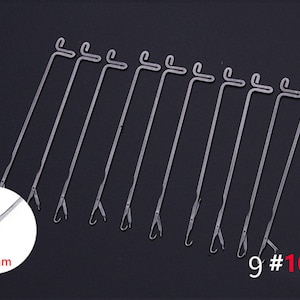 May include: A set of 10 silver-colored metal knitting machine needles, each featuring a latch hook tip and a T-shaped end. A circular inset shows a close-up of the needle tip with a 2.6mm measurement label. The text 9 #10 PCS is visible.