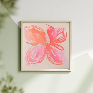 Könnte beinhalten: Ein gerahmtes abstraktes Gemälde eines rosa und orangefarbenen Schmetterlings auf einem Leinwandhintergrund.