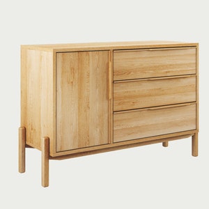 May include: A light wood dresser with three drawers and a cabinet door. The dresser has a modern design with simple lines and a light wood finish.