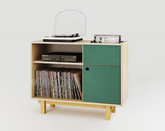May include: A wooden record player stand with a green door, two shelves, and a turntable on top. The stand has a record player, amplifier, and vinyl records on the shelves.