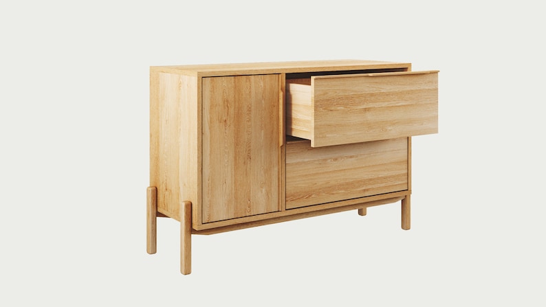 May include: A light wood cabinet with two drawers and a door. The top drawer is open, revealing the wood interior.