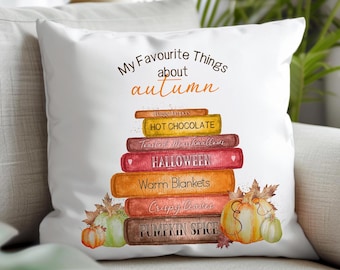 May include: White throw pillow with the text "My Favourite Things about autumn". The design features a stack of books with autumn-themed titles like "Halloween" and "Pumpkin Spice", plus pumpkin illustrations.
