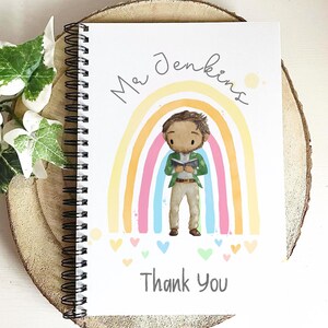 May include: Spiral-bound notebook with a colorful illustration. The cover features a cartoon teacher figure in front of a rainbow, with the name "Mr Jenkins" and the words "Thank You". The design includes hearts and a light wood background.