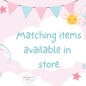 May include: A light pink background with a banner of pink and blue pennants. The text "Matching items available in store" is in a cloud-shaped text box. The image also includes a smiling sun, stars, balloons, and hearts.
