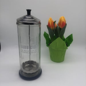 Vintage Barbicide disinfectant jar with lid that has attachment that will pull combs or tools out without using your fingers. Rubber bottom