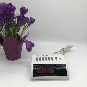 clock radio white in colour, comes with original owners manual, made by Radio shack