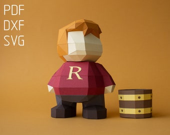 May include: Papercraft model of a red-haired character wearing a red shirt with a gold "R" on the front. The character is standing next to a brown barrel with gold bands.