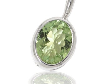 Green tourmaline silver pendant in cage setting