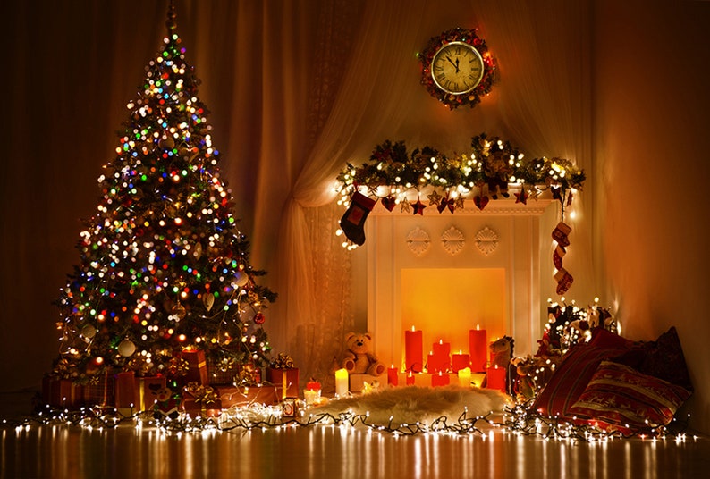 Christmas tree with presents by the fireplace with candles