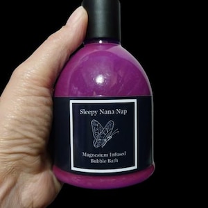 May include: A purple bottle of Sleepy Nana Nap Magnesium Infused Bubble Bath with a butterfly graphic on the label.