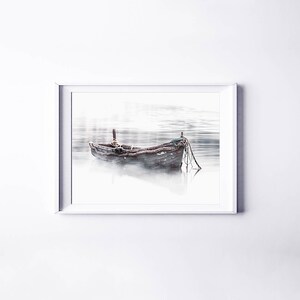 May include: A weathered wooden boat sits in a misty lake. The boat is tied to a dock with ropes. The water is calm and still, and the mist is swirling around the boat.