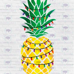 May include: A yellow pineapple with green leaves and colorful string lights wrapped around it. The pineapple is on a white brick background.