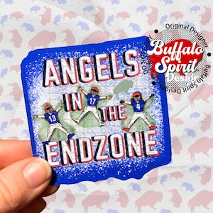 May include: Blue and red sticker with the text "Angels in the Endzone" and three cartoon football players in blue and red uniforms. The sticker has a white snow-like effect.