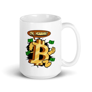 May include: White ceramic mug featuring a cartoon illustration of a Bitcoin bursting through a wall, with dollar bills flying around it. The Bitcoin is smiling and has the words "Oh, Yeaahh!" in a speech bubble above it.