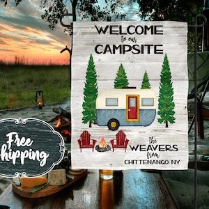Peut inclure: Une pancarte en bois blanc avec le texte "Bienvenue à notre camping The Weavers de Chittenango, NY". La pancarte présente une illustration de style dessin animé d'un camping-car vintage, de pins et d'un feu de camp.