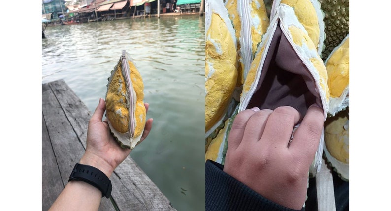 May include: A yellow durian fruit purse with a zipper opening. The purse is made from the shell of the durian fruit and has a soft brown lining.