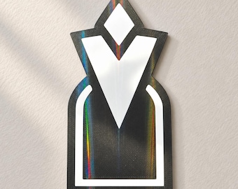 May include: A wall-mounted decorative sign featuring a black, holographic surface with a pointed, diamond-shaped top and a rectangular base. The design includes a white, V-shaped cutout in the center and a white arched border at the bottom.