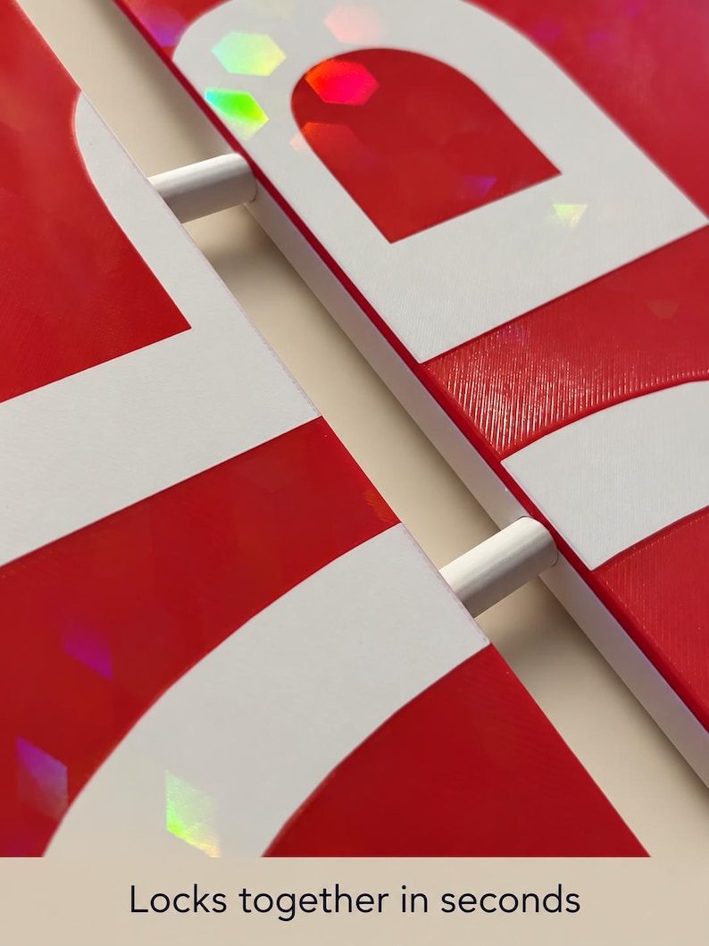 May include: Two red and white panels with a holographic finish featuring geometric shapes. The panels are connected by two white cylindrical rods. The text "Locks together in seconds" is printed at the bottom of the image.