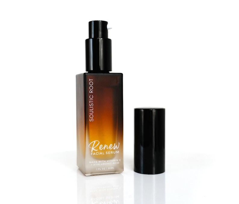 May include: A square, gradient-colored bottle of facial serum with a black pump and cap. The bottle is labeled "Soulistic Root Renew Facial Serum" and contains 1 fl oz / 30ml. The serum is made with Vitamin C and Hyaluronic Acid.