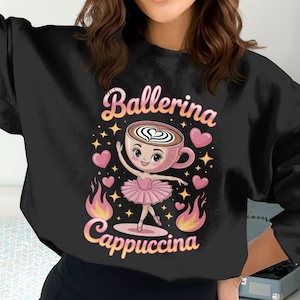May include: Black sweatshirt featuring a cartoon ballerina in a pink tutu, holding a coffee cup with a heart design. The words "Ballerina Cappuccina" are above and below the image, with hearts and stars.