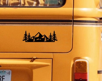 May include: A black silhouette of a mountain range with three pine trees on either side, on a yellow vintage van.