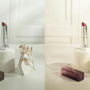 Puede incluir: Un labial rojo en un tubo plateado se exhibe sobre un pedestal blanco, junto a una forma geom&eacute;trica blanca y un objeto rectangular morado oscuro. Ramitas de plantas secas a&ntilde;aden detalle. La iluminaci&oacute;n es suave y difusa.
