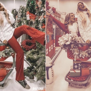 May include: Two women are laughing while riding in a shopping cart decorated with Christmas greenery and gifts. The cart is in a store aisle with Christmas trees and other decorations in the background.