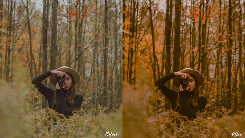 May include: A woman wearing a wide-brimmed hat and a black turtleneck sweater poses in a forest setting. She is holding a camera up to her face and looking through the viewfinder. The trees in the background are mostly bare, with some leaves still clinging to the branches. The ground is covered in fallen leaves and ferns.