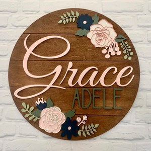 24" round floral shiplap baby name sign for nursery or shower decor featuring beautiful roses and flowers with a custom 3d name