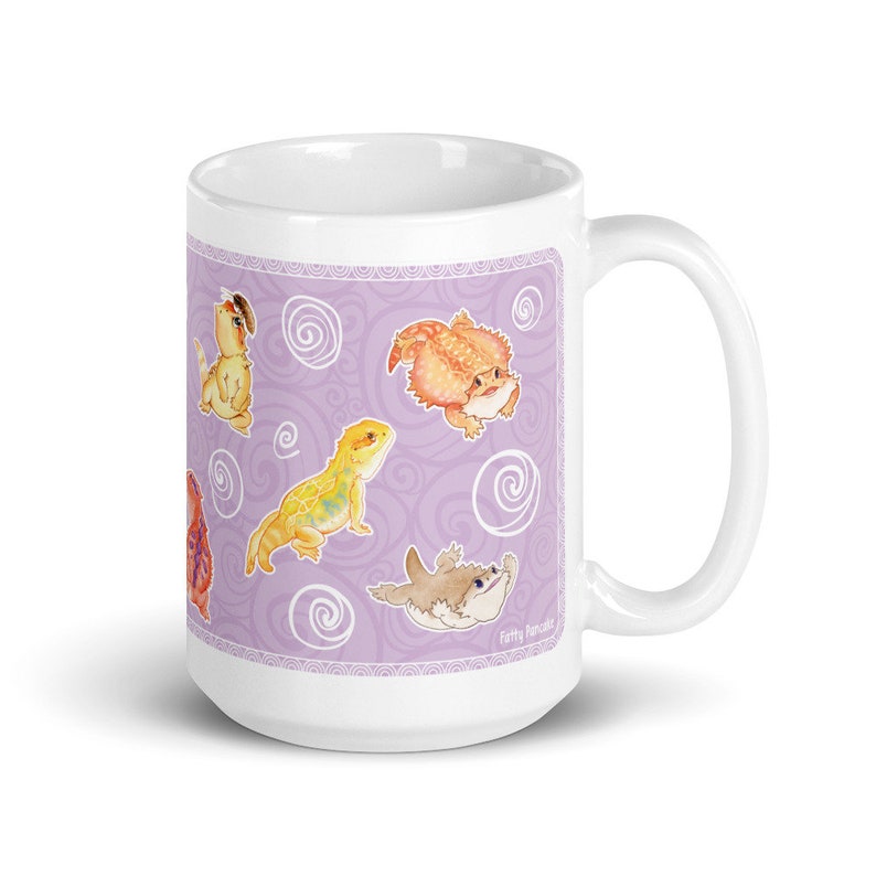 May include: White ceramic mug with a purple background and a pattern of swirling lines. The mug features a design of multiple cartoon bearded dragons in various poses. The text "Fatty Pandas" is printed on the bottom right corner of the mug.