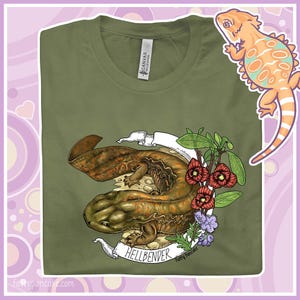 May include: A green t-shirt featuring a graphic of a Hellbender salamander surrounded by flowers and a banner that reads "Hellbender" and "Fatty Pancake".