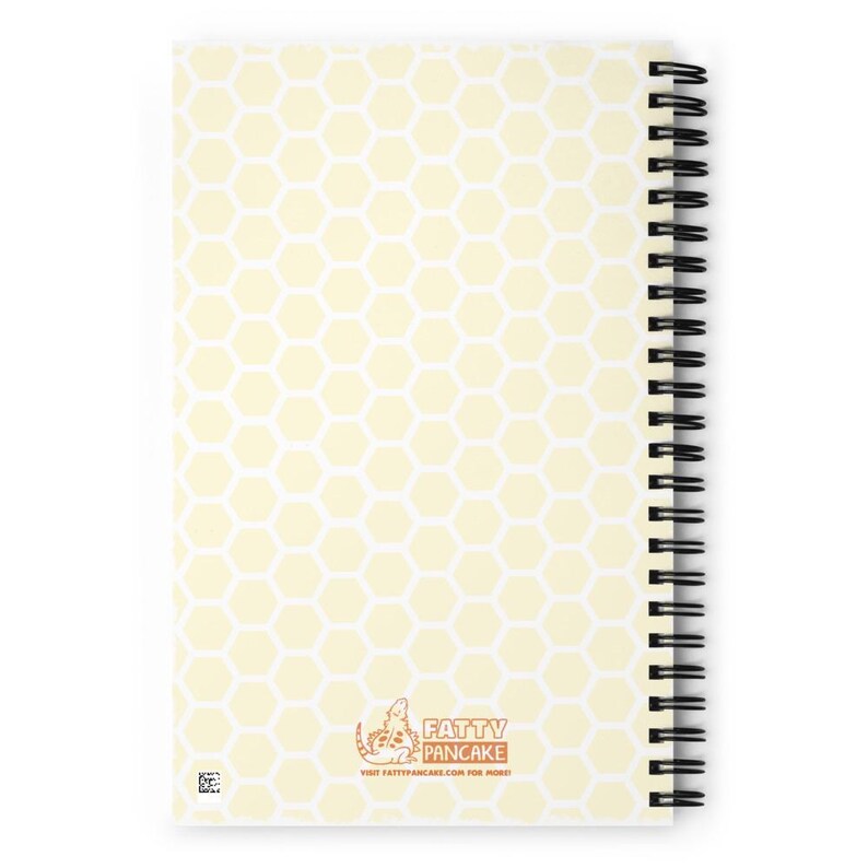 A spiral-bound notebook with a pale yellow honeycomb pattern cover and the Fatty Pancake logo near the center bottom. The notebook is displayed on a bright white background.