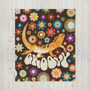 May include: A brown throw blanket with a colorful floral pattern and a bearded dragon with the word "Groovy" in a retro font.