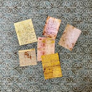 May include: Six vintage paper documents with handwritten text on a patterned background. The documents are in various sizes and shapes, and the text is in a variety of styles.