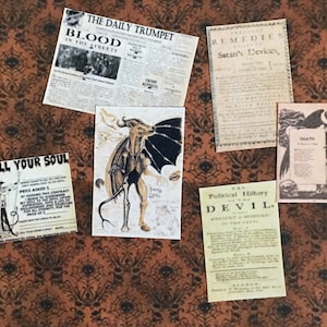 May include: Five vintage paper ephemera pieces with a dark brown background. The pieces include a newspaper clipping titled "Blood in the Streets", a poster titled "Sell Your Soul", a poster titled "The Political History of the Devil", a poster titled "Remedies for Satan's Devices", and a poster titled "Death" with an illustration of a winged figure.