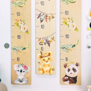 May include: Three wooden growth charts with animal illustrations. The charts feature a koala, a lion, and a panda. Each chart has a scale marked in inches from 80 to 120.