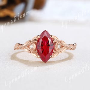 Unik fyrverkerislipad rubinförlovningsring naturinspirerad bladring i gult guld med moissanitbezel och födelsesten i rubin, jubileumspresent