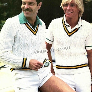 May include: Two men wearing white cable knit sweaters with green and yellow trim. The sweaters have a v-neck and are worn with white shorts. The men are standing in front of a car.