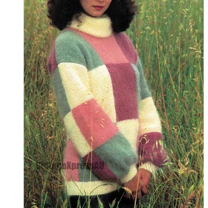 May include: A woman wearing a multi-coloured knitted jumper with a turtleneck and a burgundy beret. The jumper has a patchwork design with squares of pink, white, green, and light blue.