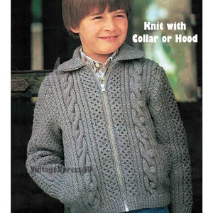 May include: A gray knitted cardigan with a zipper closure and cable knit detail. The cardigan has a collar and pockets. The text "Knit with Collar or Hood" is visible in the image.