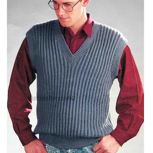 May include: A blue knitted waistcoat with a V-neck. The waistcoat has a ribbed texture and is worn over a red button-down shirt.