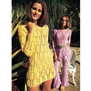 May include: Two women wearing crocheted dresses. The woman on the left is wearing a yellow dress and the woman on the right is wearing a purple dress. Both dresses have a lacy pattern.