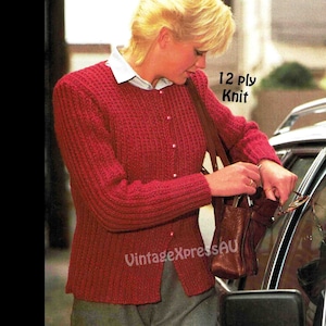 May include: A red knitted cardigan with a button closure and a brown leather shoulder bag. The cardigan is made with 12 ply knit yarn.