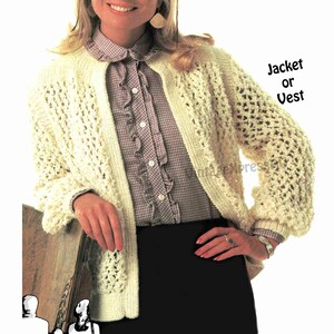 May include: A white crocheted cardigan with a button-up front and a lacy pattern. The cardigan is worn over a plaid shirt with a ruffled collar. The text "Jacket or Vest" is visible in the image.
