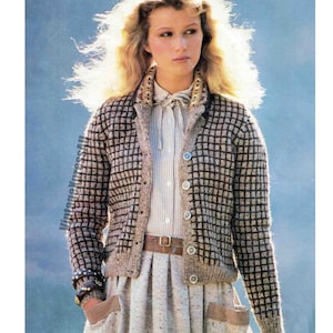 May include: A brown and black checked cardigan with a collar and button fastening. The cardigan is worn over a white striped shirt and a brown belt.