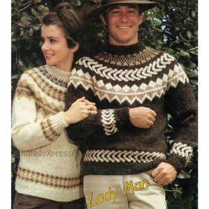 May include: A pair of brown and white patterned sweaters with a high neck. The sweaters have a geometric design with brown, white, and beige colors.