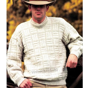 May include: A white knitted sweater with a textured pattern. The sweater has a crew neck and long sleeves.